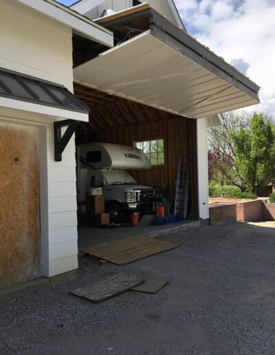 A garage with a rv parked in it.