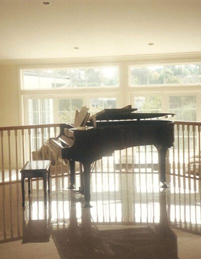 A grand piano in a hallway.